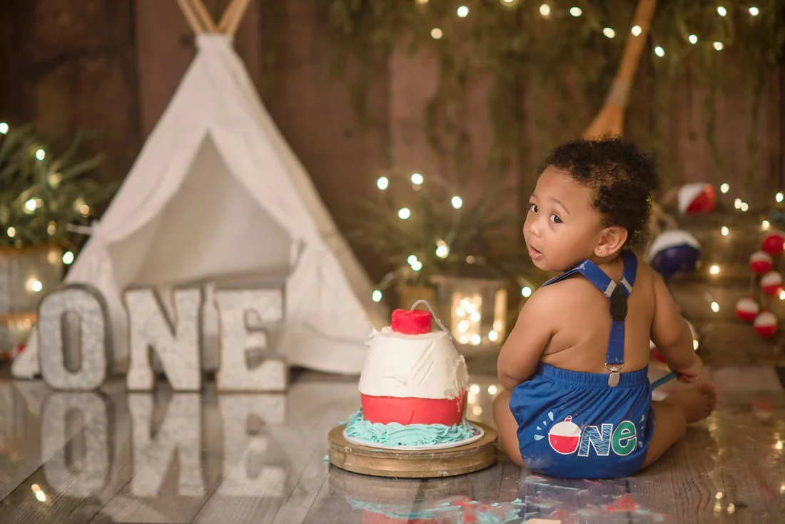 Birthday boy looking back over his shoulder during the cake smash