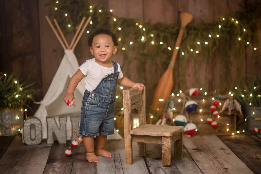 Birthday boy standing beside a small wooden chair