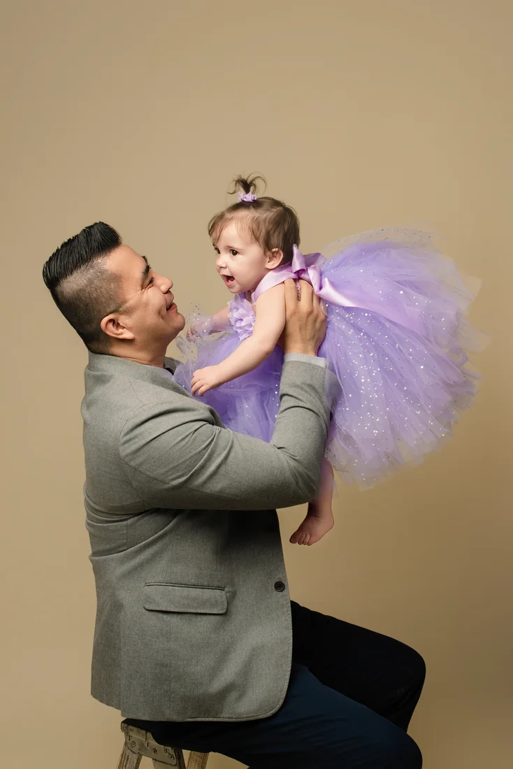 Father lifting Stephanie as they look at one another